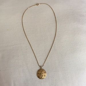 Gold sand dollar necklace